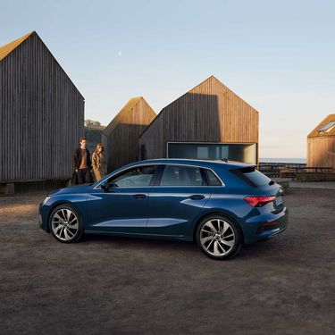 Side view of the Audi A3 Sportback with models at the front